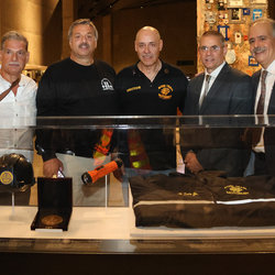 (l-r): Previous medal winners Dom Spagnolo, Alan Grande, and Hector Soto, who was also honored this year, stand with Local 100 Pres. John Chiarello and Exec. Board Member Mario Galvet in front of glass case containing transit artifacts