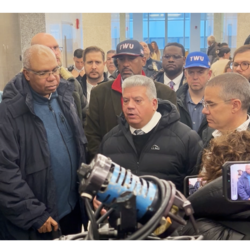 Myran Pollack, center, flanked by Brooklyn DA Gonzalez and President Chiarello